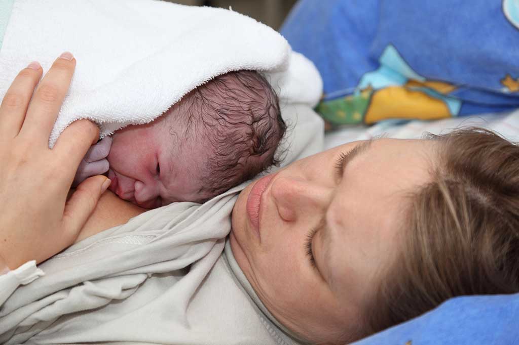 Mother with newborn after long labor.
